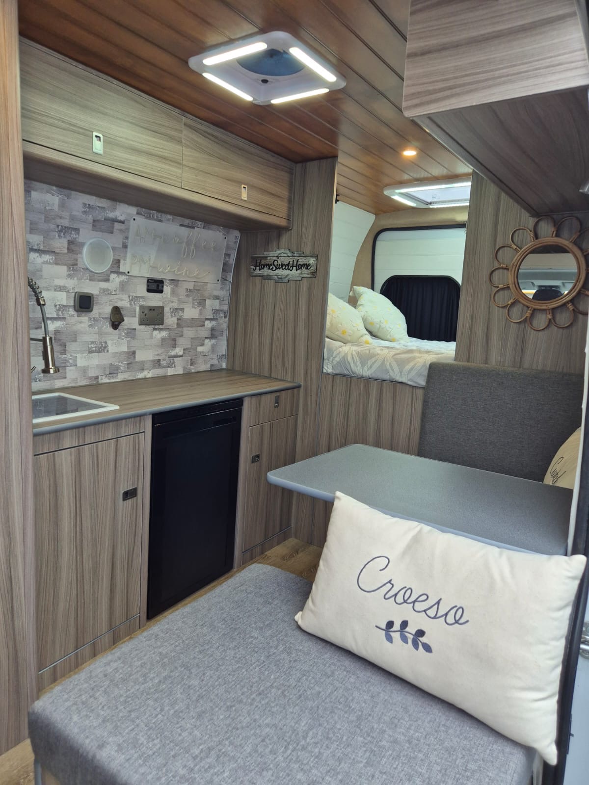 Interior of a WD Campervan conversion showing bed and kitchen area